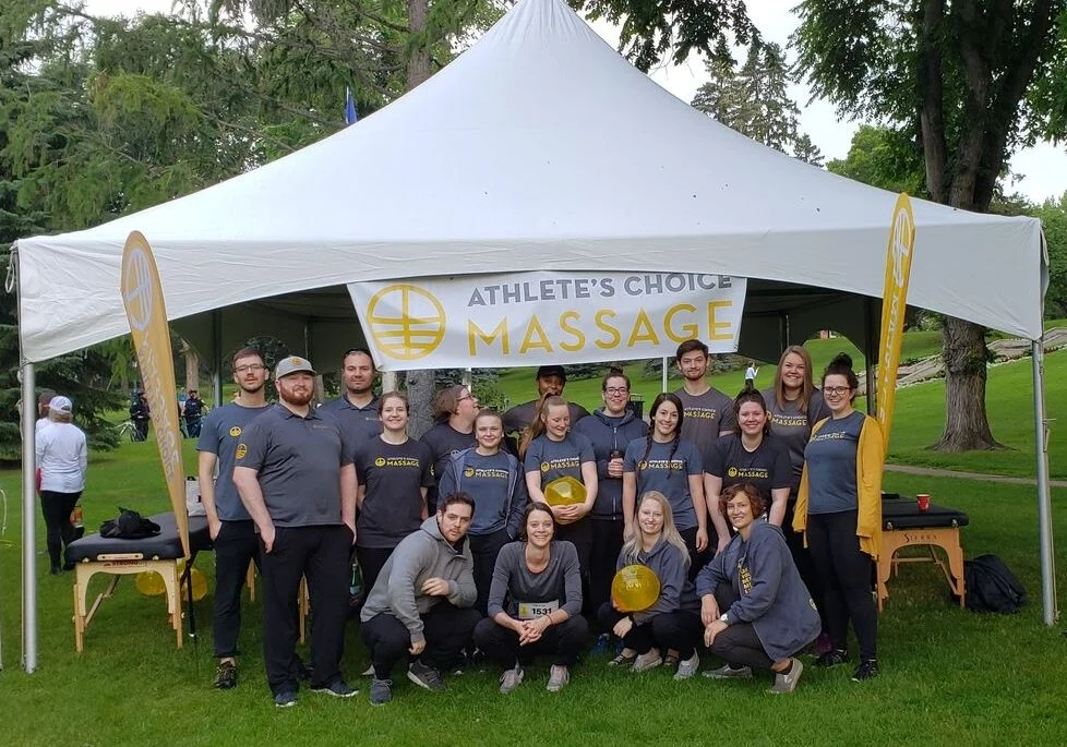 The Athlete's Choice Massage team under their branded tent at a community event