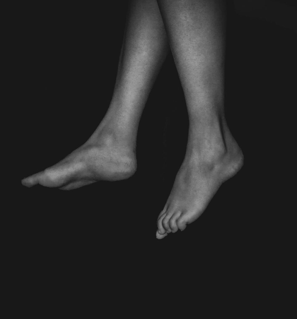 a black and white photo of a person's legs