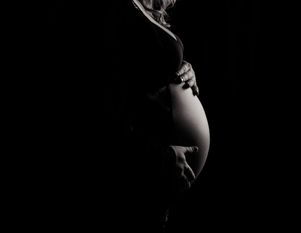 pregnant woman holding tummy